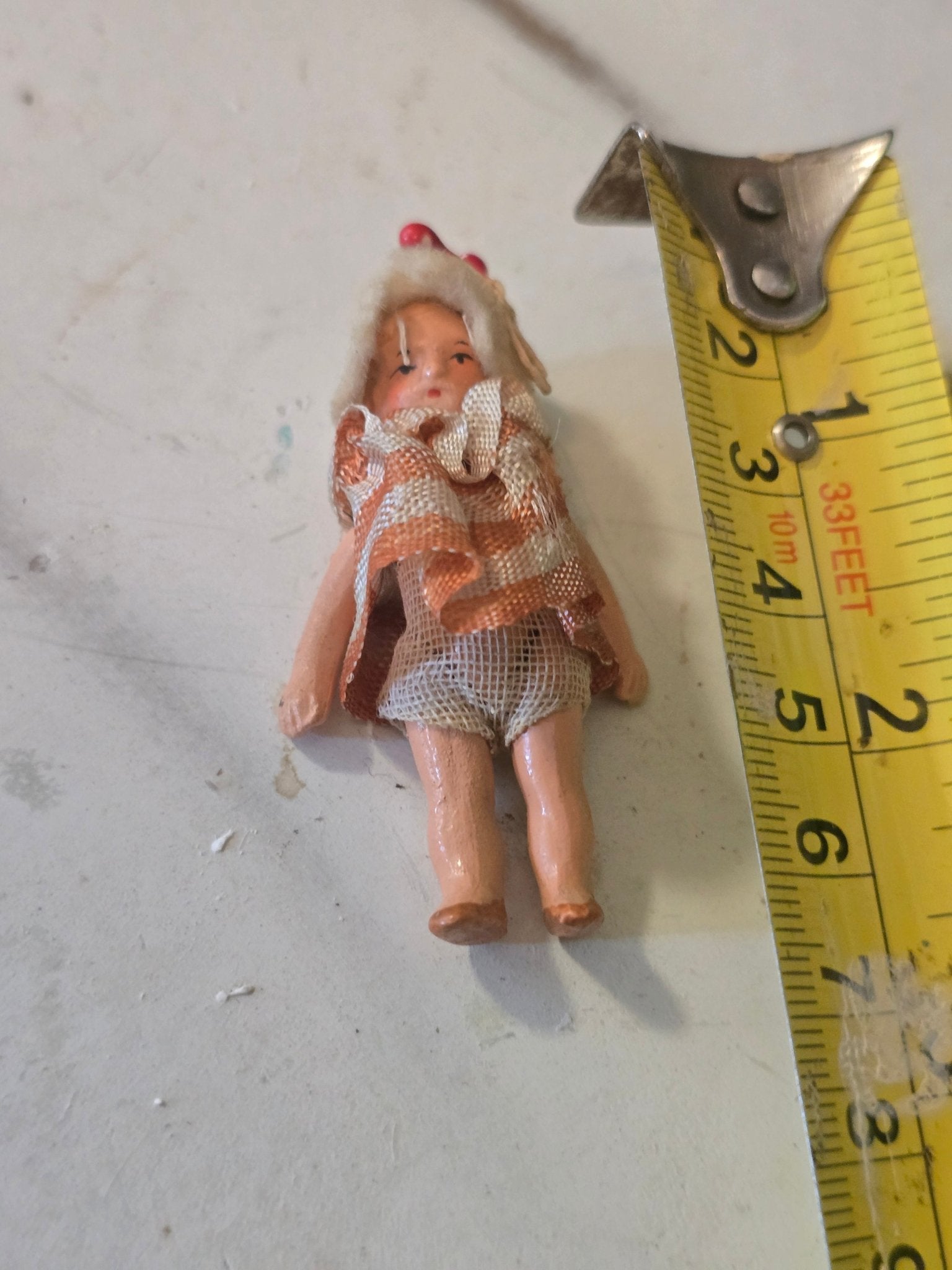 Antique 2.5" Miniature Jointed Doll – Hand Painted Metal/Hard Plastic – Original Dress & Hat w/ Berry - Bayshore Treasures