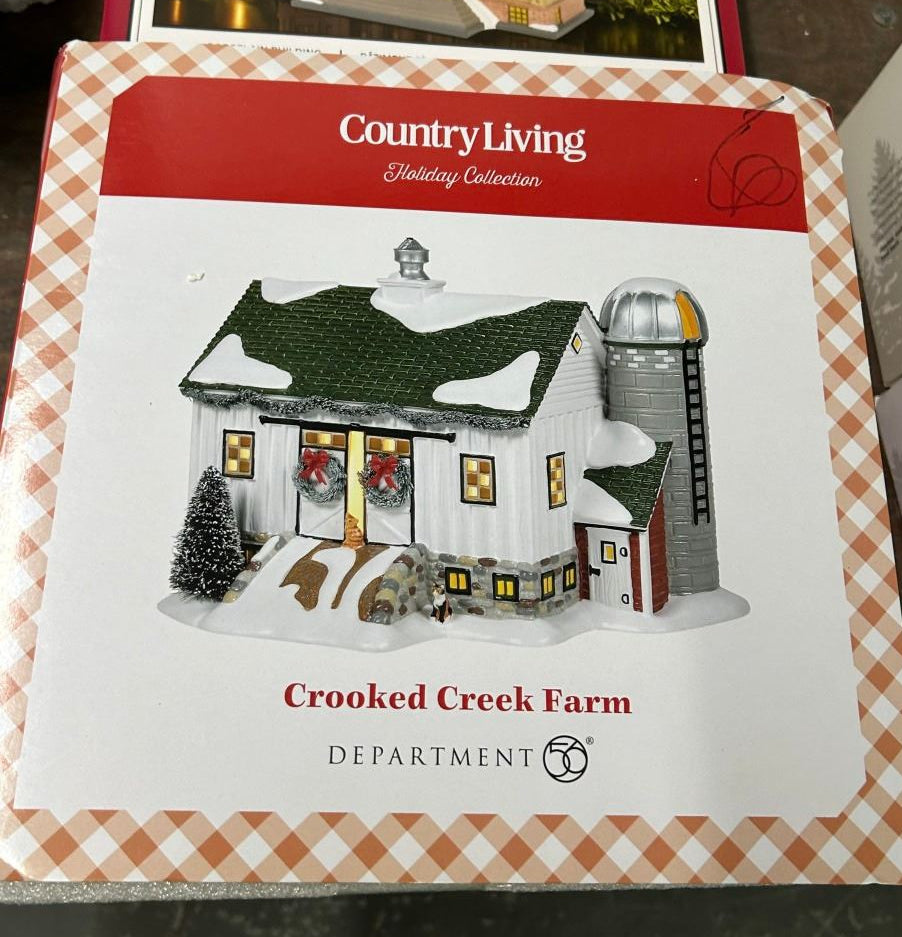 Department 56 Crooked Creek Farm Country Living Christmas house with barn-style, snow-covered roof and silo.
